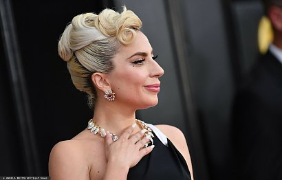 Lady Gaga od dłuższego czasu wybiera stylizacje w stylu glamour, w których wygląda wręcz posągowo. Tak było też i tym razem, w pomysłowym koku stworzonym z przekładanych pasm włosów wyglądała bardzo elegancko. Wisienką na torcie był lok spoczywający z boku czoła.